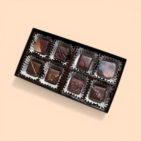 Box of assorted chocolates on a beige background