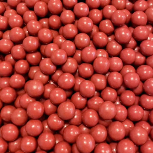 A close up photo of many roasted strawberry malt balls