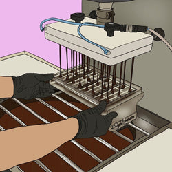 An illustration of a Monsoon Chocolate employee heating and cooling chocolate to temper it